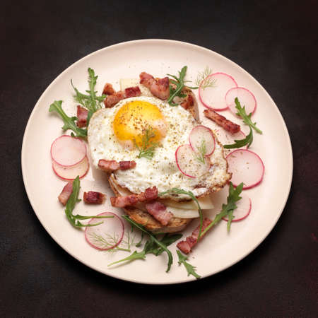 Fried egg with vegetables, ham and cheese. Top view.