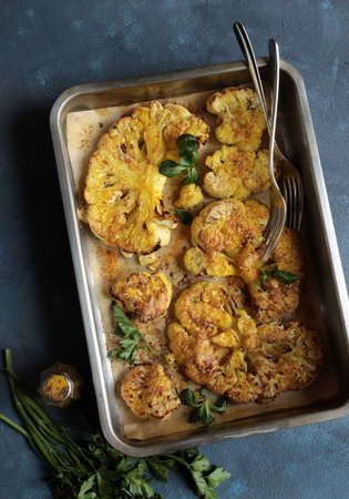 Fried cauliflower isolated on gray background. High angle view.の写真素材