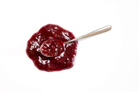A spoon with strawberry jam sauce isolated on whiteの写真素材
