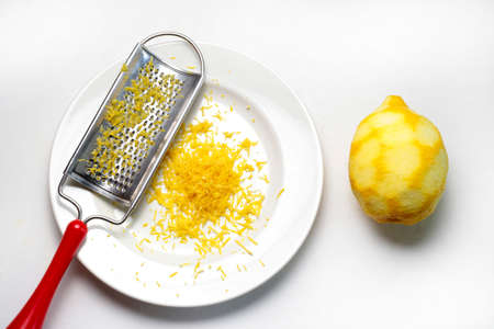 Grater and lemon zest isolated on white background. Directly above.の写真素材