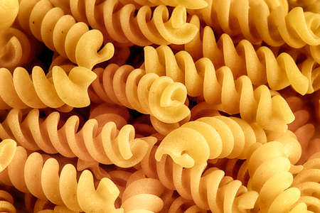 Healthy food concept. Closeup of Italian dry fusilli pasta. Fusilli pasta pattern background. Flour products.の写真素材