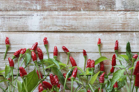 Red hot chili peppers on wooden table. Directly above.