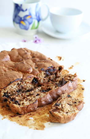 Homemade cake with chocolate chips on white background. Close-up.