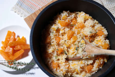 Delicious pumpkin risotto with fresh thyme and parmesan in a pot. Italian Cuisine. Directly above.の写真素材