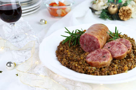 Cotechino with lentils served on a plate. Christmas decorations. Italian food.の写真素材