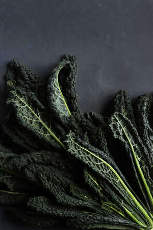Raw fresh black cabbage texture and background. Black kale. Directly above.