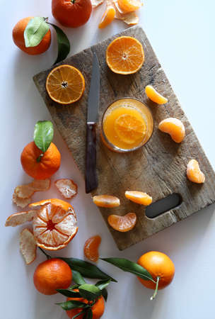 Tangerine juice in glass and fresh fruit. Heathy food. Directly above.
