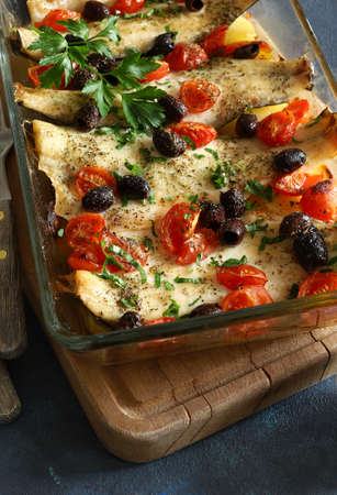 Baked sea bass fillets with cherry tomatoes and olives. Directly above.の写真素材