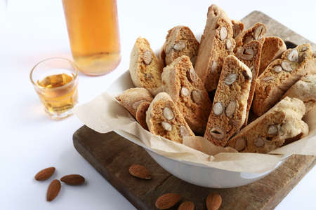 Cantucci, Italian almond cookies with sweet wine Vin Santo isolated on white background.