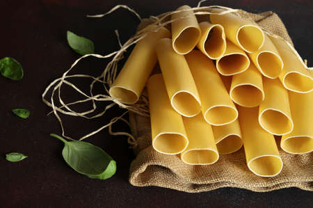 Cannelloni pasta tubes isolated on black background. Italian food. Close-up.の写真素材