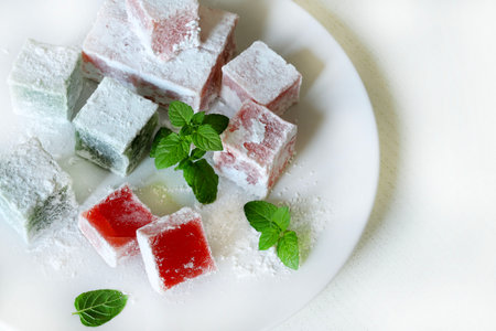 Turkish delight. Lokum, colourful, flavored gelatinous sweets covered in powdered sugar served in a...