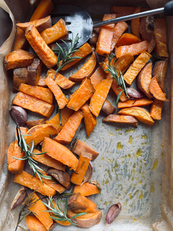 Roasted sweet potato with rosemary and garlic, top view.