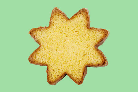 A slice of traditional Italian Christmas Pandoro, isolated on a mint background. Italian cuisine concept. Christmas and holidays season.の写真素材