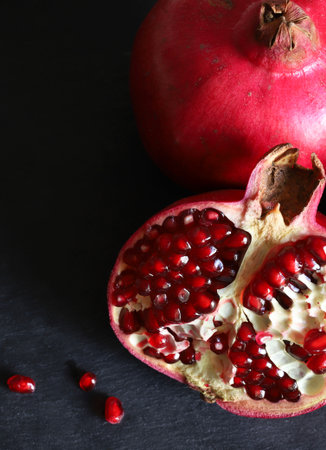 Pomegranate fruit on black background with copy space for textの写真素材