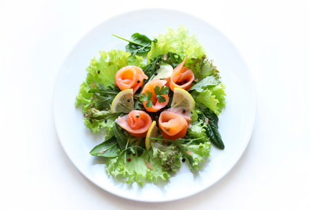 Salmon salad on white plate isolated on white background. Healthy food concept.
