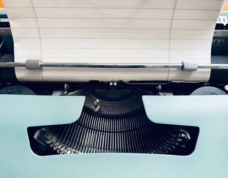 Portable typewriter isolated on a wooden background. Vintage Italian item. Overhead view.の写真素材