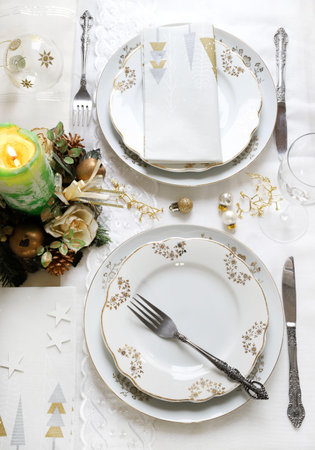 Elegant and festive setting, perfect for the Christmas table, with white, gold and silver-grey...