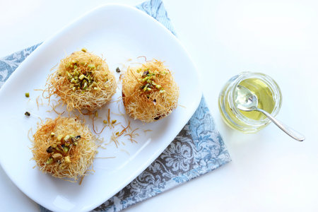 Kataifi, a typical Greek and Middle Eastern pastry specialty drizzled with honey and decorated with chopped pistachios. Kunafeh, kadenf.の写真素材