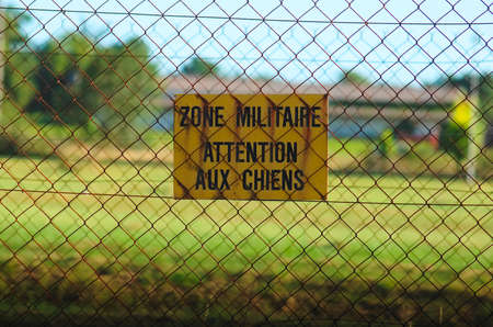Sign of warning of military zone "MILITARY AREA, BEWARE OF DOGS"の写真素材