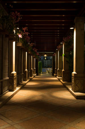 Nightshot of an outdoor walkway decorated with pillarsの写真素材