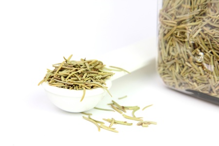 Rosemary in a spoon and a jarの写真素材
