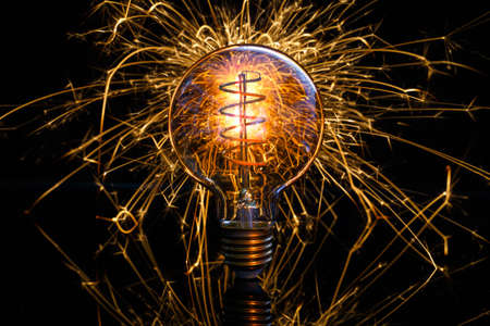Light bulb with spark backgroundの写真素材