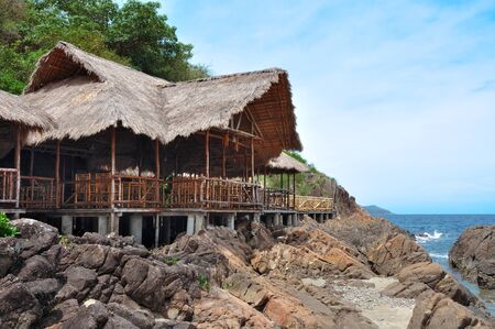 Hut built on stilts near the seaの写真素材