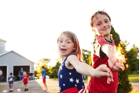 Cheerful sister and brother with Bengal lightsの写真素材