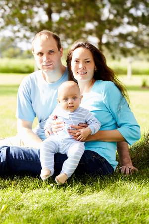 Smiling multiethnic family with newborn childの写真素材