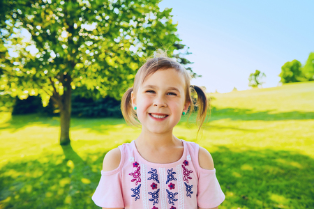 Portrait of happy little girl smiling at cameraの写真素材