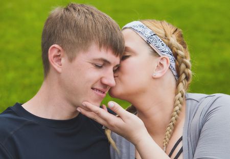 Portrait of happy woman kissing her boyfriendの写真素材