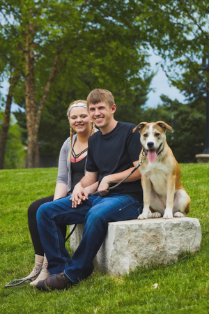 Portrait of cheerful young couple with their dogの写真素材