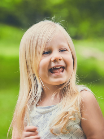 Excited face of blond little Caucasian girlの写真素材