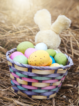 Basket with colorful eggs outside. Easter dayの写真素材