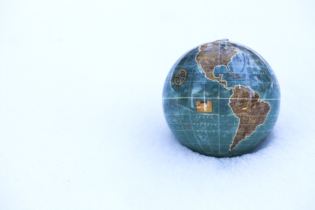 global warming and cold snap. Globe on snowの写真素材