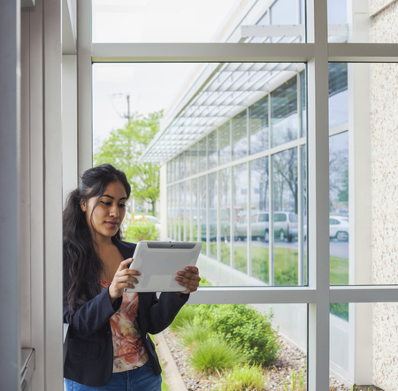Smiling student inside collegeの写真素材