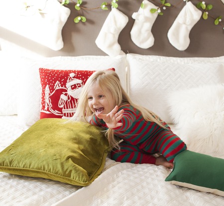 Cheerful girl catching the bubbles. Christmas timeの写真素材