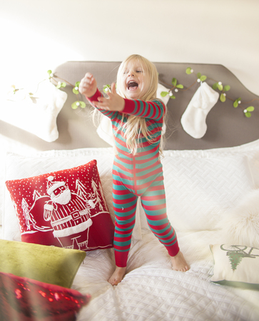 Cheerful girl catching the bubbles. Christmas timeの写真素材