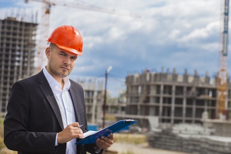 Worker inspector in helmet checking constructionの写真素材