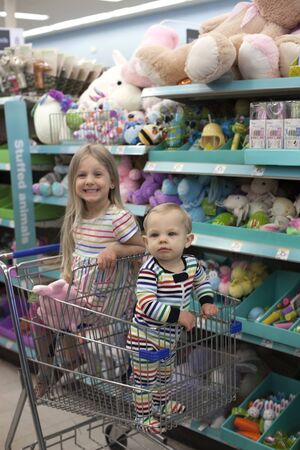 Eau Claire, WI, USA - October 20, 2019: Walgreens. Happy sister and brother doing shopping with cart in toy shopのeditorial素材