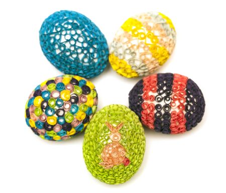 Above view of colorful quilled Easter eggs on white background. Easter symbol, holiday, celebration, springtimeの写真素材