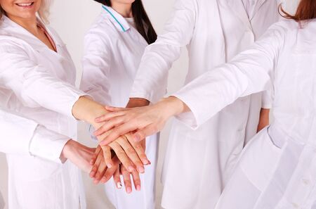 Teamwork. Conceptual photos of hands of medical personal on top of each otherの写真素材