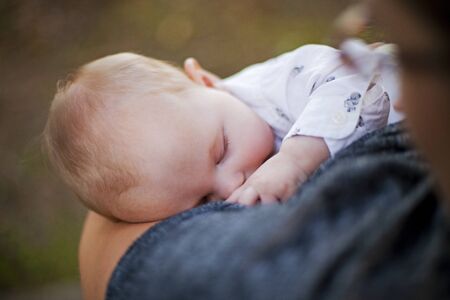 Close-up of baby boy sleeping while breastfeeding. Newborn child, motherhood conceptの写真素材