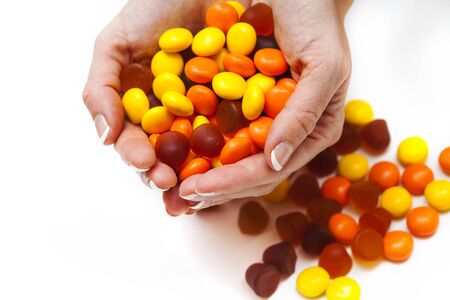 Female hands holding vitamins on white backgroundの写真素材