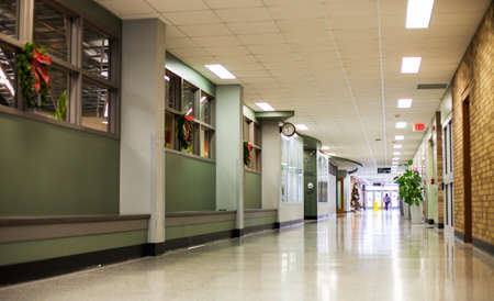 Eau Claire, WI, USA - December, 20, 2019: Chippewa Valley Technical College. Empty hall in college building decorated with Christmas wreaths. Perspective of hallwayのeditorial素材
