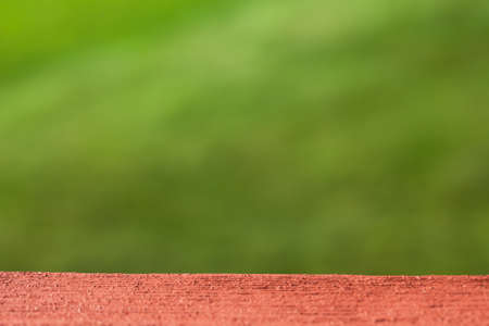 Blurred background of green grass and table.の写真素材