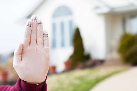 Stop corona virus. Conceptual photo of female hands in medical gloves with faces on fingers next to...