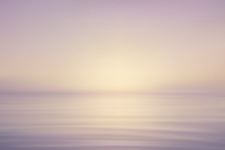 Warm pastel colors with minimal waves and gentle morning glow on waterのイラスト素材