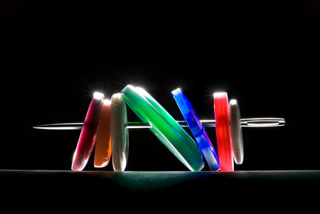 Multi-coloured buttons and needle  Art illumination  A black background の写真素材