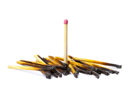 Many the spoiled matches on a white isolated background  One match the whole の写真素材